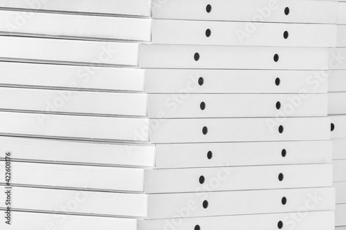 White cardboard packaging for pizza boxes pile a close up background