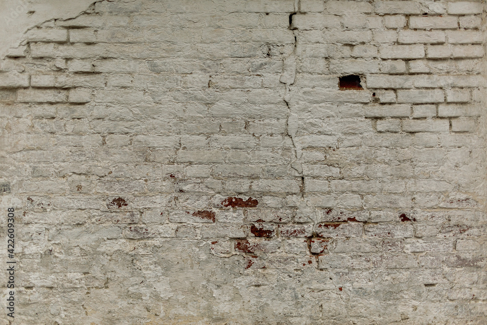 Old faded dirty wet shabby brick wall of ancient ragged facade. Uneven pitted fissured stone. Rusted rot, messy cracked stiff blocks. Retro white grimy rusty daub brickwall for 3D rustic grunge design Old faded dirty wet shabby brick wall of ancient ragged facade. Uneven pitted fissured stone. Rusted rot, messy cracked stiff blocks. Retro white grimy rusty daub brickwall for 3D rustic grunge design