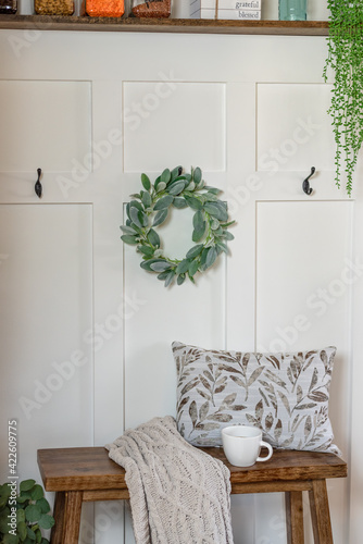 Canvas Print Board and batten accent wall with a small decorative bench