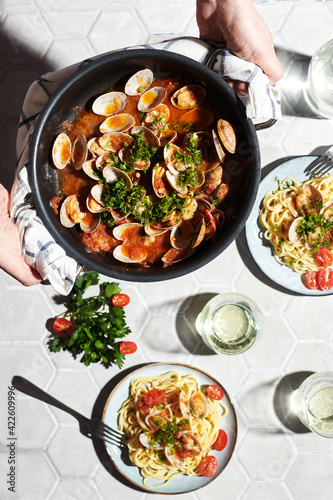 Mediterranean cuisine: pasta with seafood, with vongole. Italian lunch. Lifestal mood. Light background, top view photo