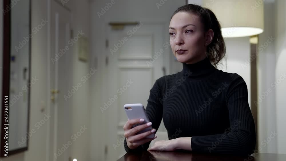 doubting woman is sitting at home with mobile phone, deciding calling or not, waiting call doubting woman is sitting at home with mobile phone, deciding calling or not, waiting call