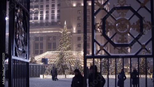 New Year celebrations in the city. Passers-by pass through a large gate.