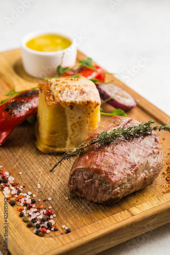 restaurant dish with grilled meat and vegetable side dish