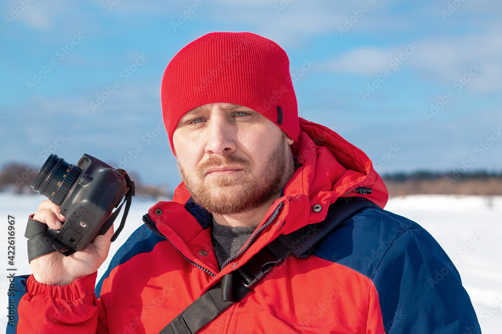 Photographer on a winter landscape with a camera in his hands. Photographer on a winter landscape with a camera in his hands.