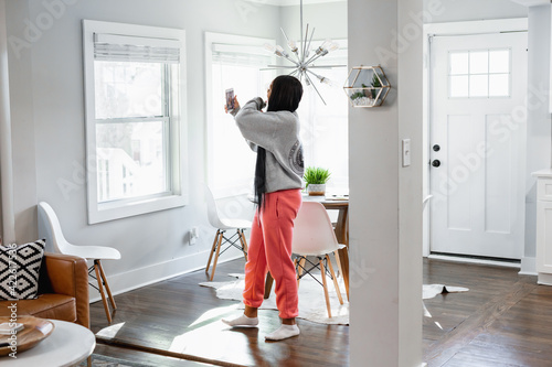Black teen girl on social media at home