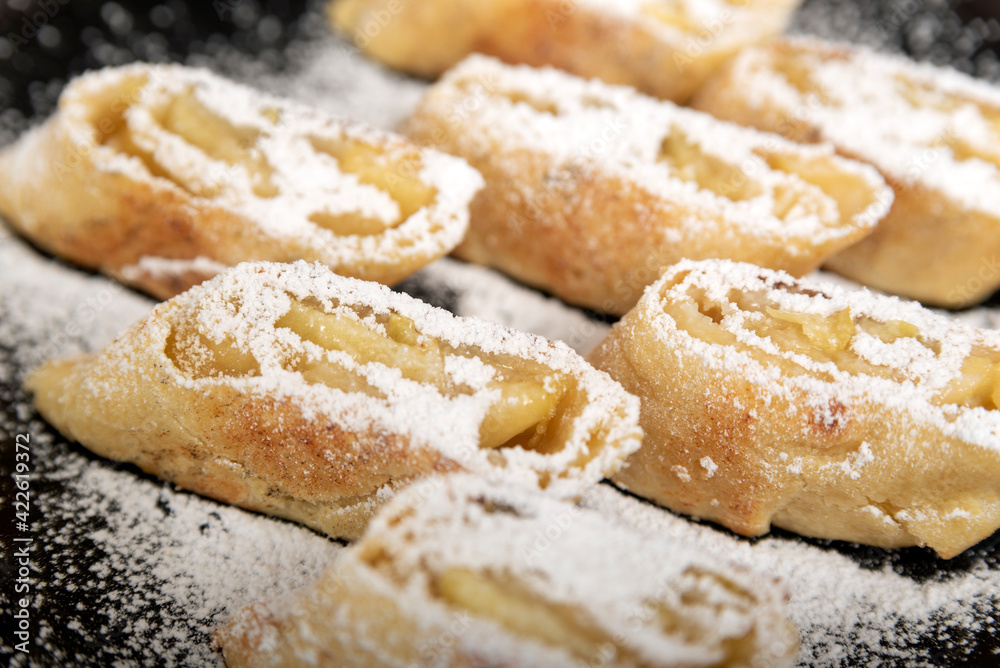 Apple roll with powdered sugar. Close up
