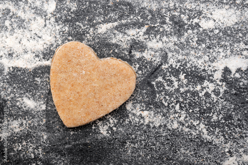 Obraz premium Harvesting heart-shaped dough for making cookies. Shortbread.