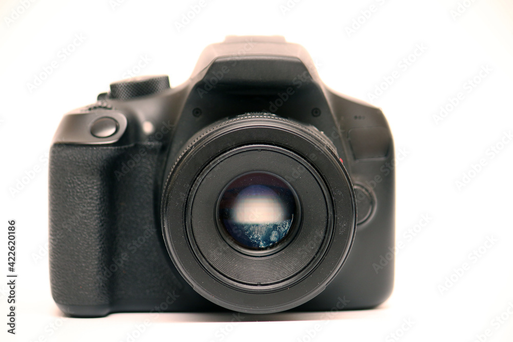 No logo digital single-lens reflex camera camera with 50 mm 1.8 aperture prime lens without hood. Front view studio shoot on white background No logo digital single-lens reflex camera camera with 50 mm 1.8 aperture prime lens without hood. Front view studio shoot on white background
