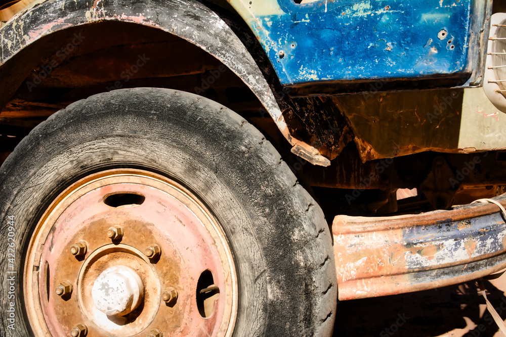 Grunge style shot of outworn and deteriorated front tyre of an old truck.