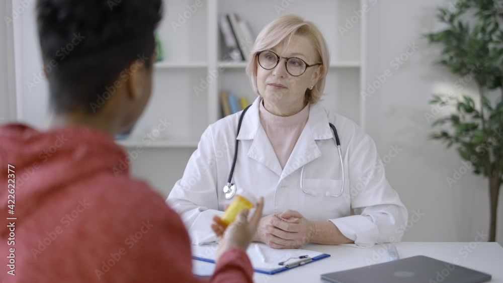 Therapist giving male patient bottle of pills prescribing medication, healthcare Therapist giving male patient bottle of pills prescribing medication, healthcare