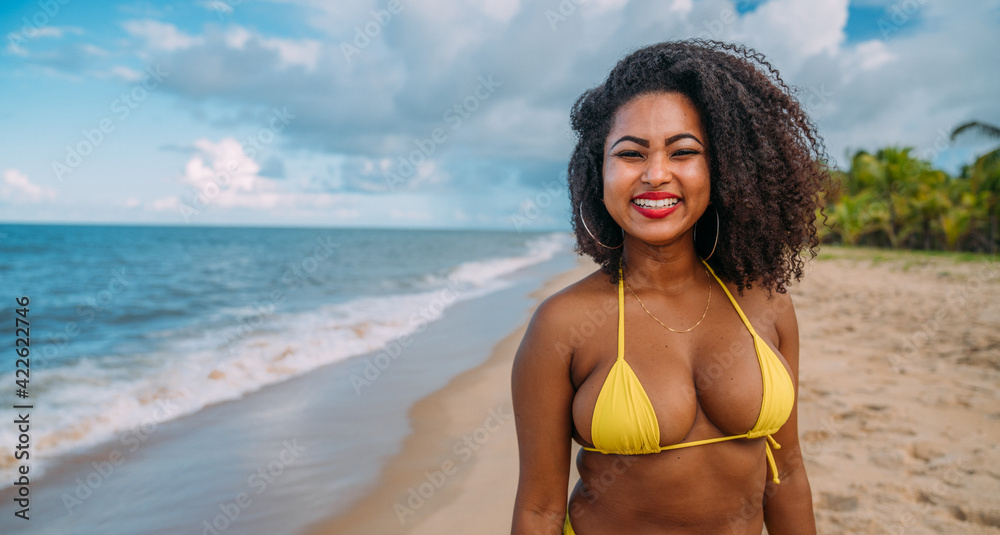 beautiful Latin American woman in bikini on the beach. Young woman enjoying her summer vacation on a sunny day, smiling and looking at the camera beautiful Latin American woman in bikini on the beach. Young woman enjoying her summer vacation on a sunny day, smiling and looking at the camera