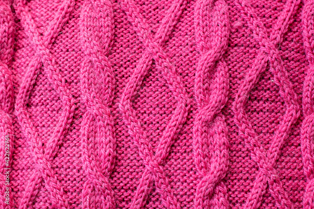 Hand knitted pink woolen sweater details background