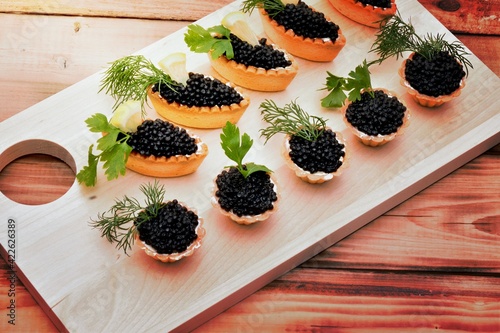 Tartlets with black caviar