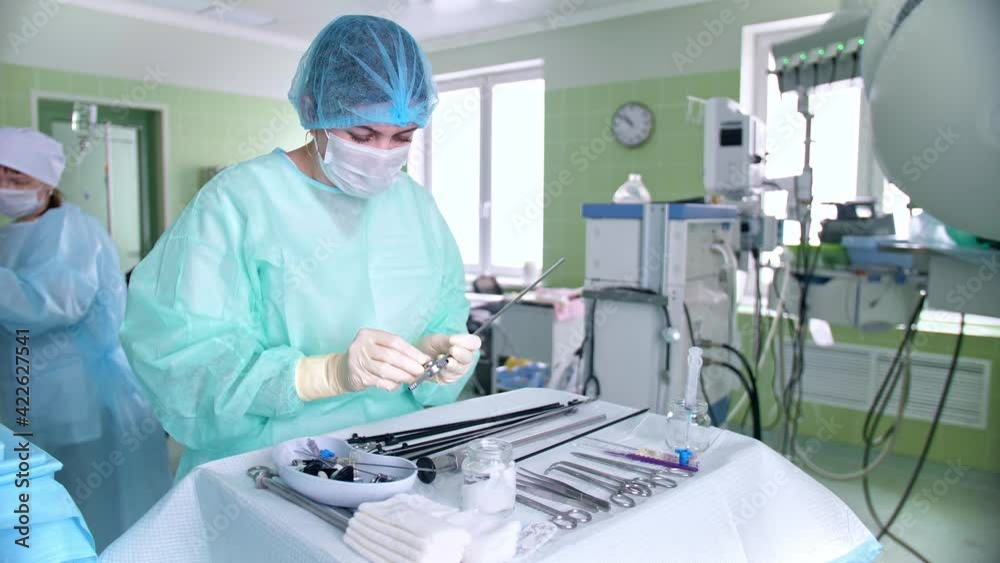 Surgeon's assistant prepares tools for surgery Surgeon's assistant prepares tools for surgery