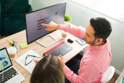 Top view of business colleagues looking at a work presentation