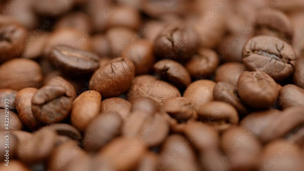 Roasting coffee beans. Close up in fragrant coffee beans smoking. Fragrant coffee beans being roasted. Coffee beans macro rotating Roasting coffee beans. Close up in fragrant coffee beans smoking. Fragrant coffee beans being roasted. Coffee beans macro rotating