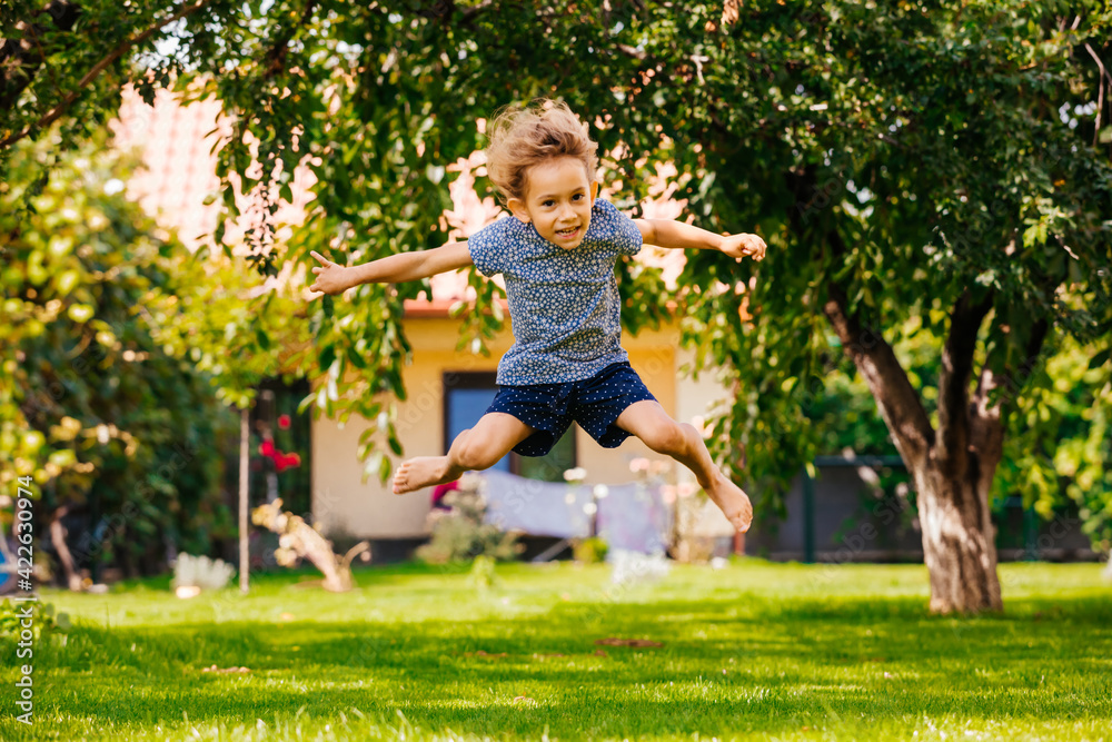 Active little girl has fun on the backyard Active little girl has fun on the backyard