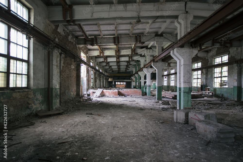 Abandoned factory. Large empty industrial hall with garbage Abandoned factory. Large empty industrial hall with garbage