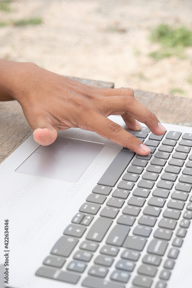 Latin hand typing on the computer. Hispanic man, using laptop. No face. Vertical. Latin hand typing on the computer. Hispanic man, using laptop. No face. Vertical.