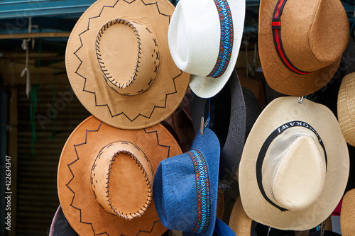 Shop with hats of various styles in the street market. Showcase with hats