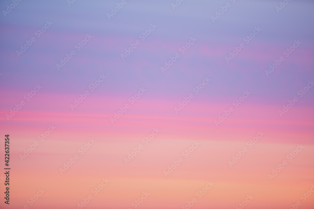 Beautiful backdrop of sunset sky of pink orange lilac violet magenta colors. Colorful smooth dawn sky gradient. Nature background of sunrise. Amazing morning heaven. Slightly cloudy evening atmosphere