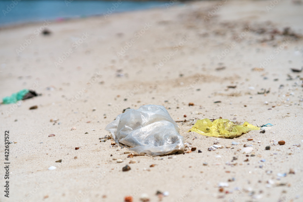 Trash on the sandy beach left by vacationers Trash on the sandy beach left by vacationers