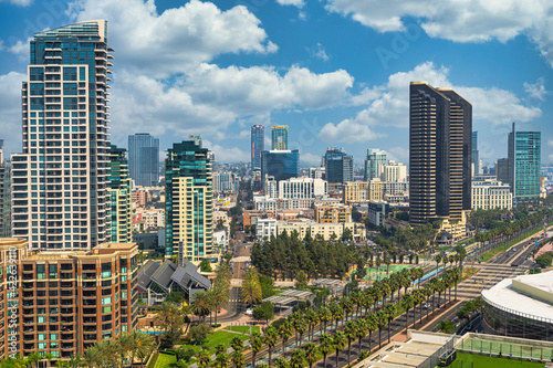 Aerial view of the city of San Deigo, CA downtown gaslamp district skyline filled with skyscrapers, hotels, business centers against a beautiful vivid cloud filled blue sky photo