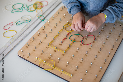 Exploring basic math and geometry concepts with geoboard photo