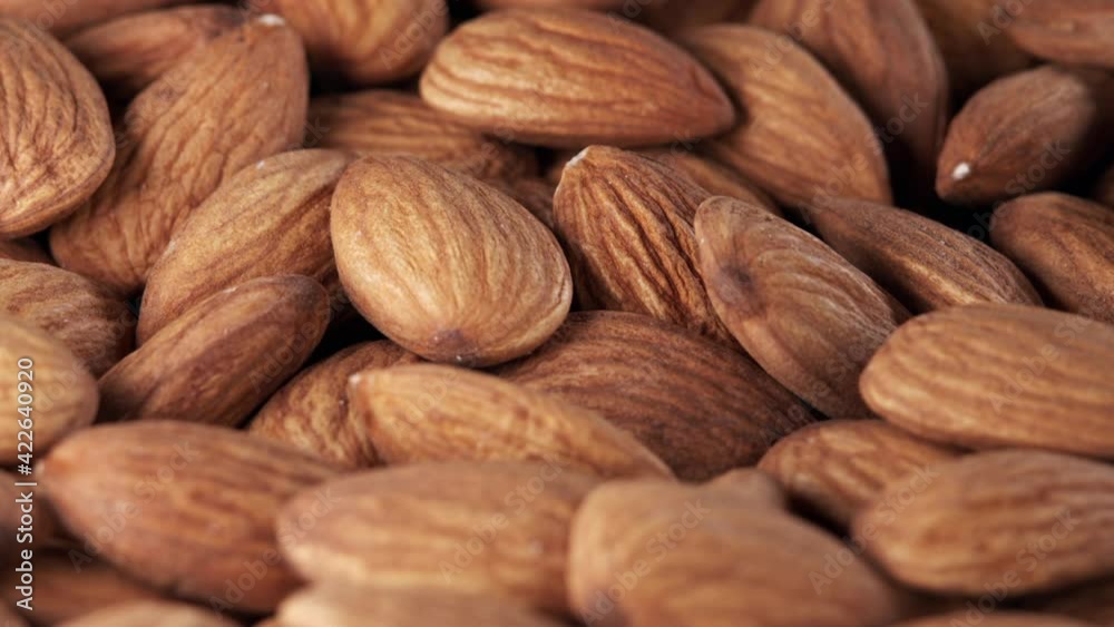 Nut almond close up. Product rich in minerals and vitamins. Almond turns in a shot. Almond kernels rotating. Close up food background. Nut almond close up. Product rich in minerals and vitamins. Almond turns in a shot. Almond kernels rotating. Close up food background.