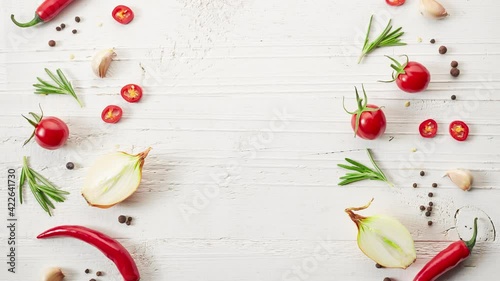 Wallpaper Mural various spices and tomatoes slide from top to bottom on a painted white wooden table top. stop motion animation Torontodigital.ca