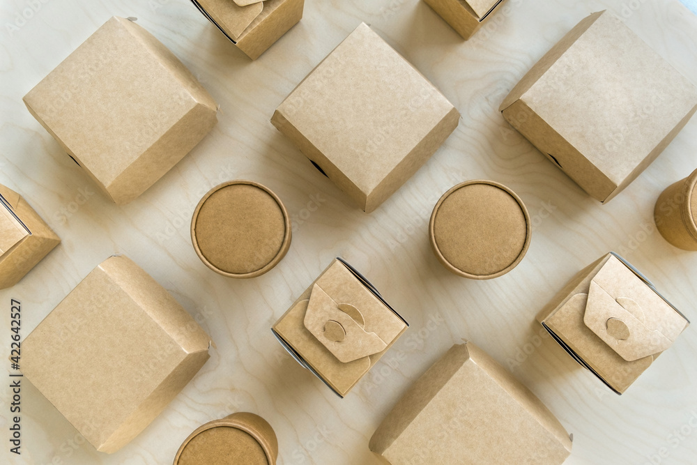 Flat lay of different dispasable paper boxes and cups on wooden texture. Flat lay of different dispasable paper boxes and cups on wooden texture.