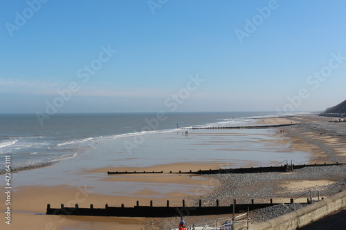 Cromer, Nortfolk, coast from the top, people walking on the bech winter, seaside gentle waves crashing on the shore, north sea, seascape, northern Europe, beautiful Englad  © BC-Consulting