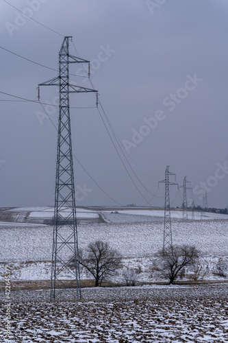 Electricity pylons running through arable fields