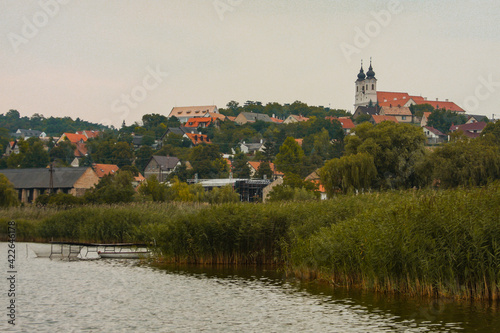 View of Tihany village on the edge of balaton lake on a summer day. vicible church and some houses