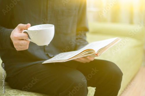person relaxing at home  reading book and drink tea  having rest in the evening