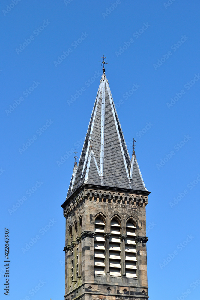 Church Steeple with Slate Tiles & Louvred Belfry against Clear Blue Sky