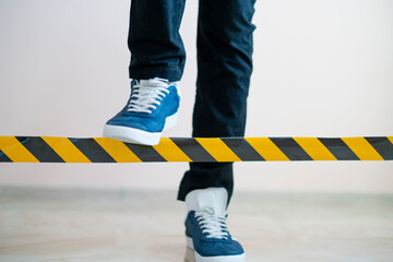 person cross the black and yellow stop line, braking the limit concept
