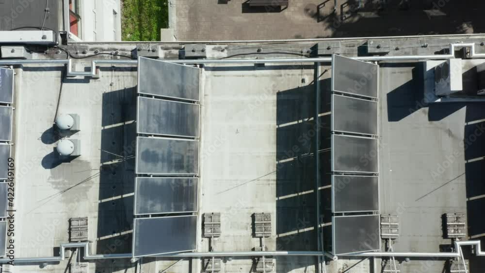Top view on alternative energy sources and a solar panel installed on the roof of a sports school for the production of environmentally friendly energy. aerial view. Top view on alternative energy sources and a solar panel installed on the roof of a sports school for the production of environmentally friendly energy. aerial view.