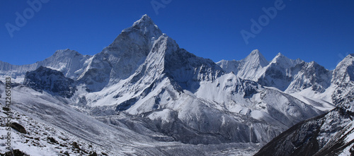 Clear blue sky over snow covered Mount Ama Dablam.