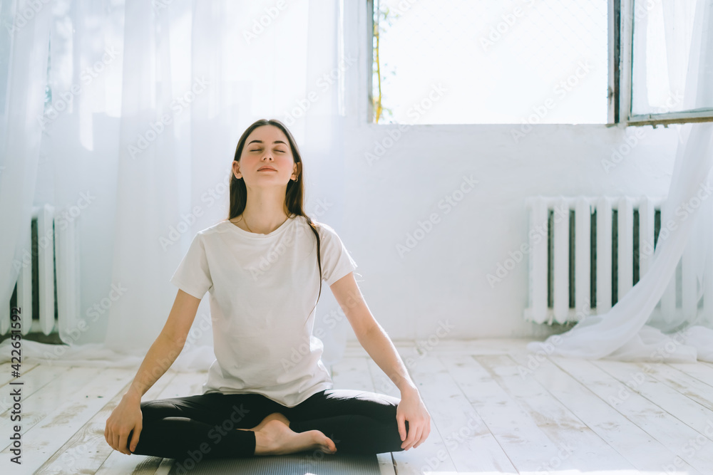 Beautiful brunette fitness woman meditate, doing yoga indoors at home. Staying fit and healthy Beautiful brunette fitness woman meditate, doing yoga indoors at home. Staying fit and healthy