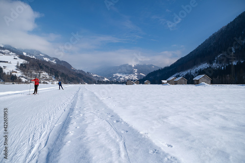 Winter mountain landscape with groomed cross-country trails. Swiss Alps  Switzerland  Europe