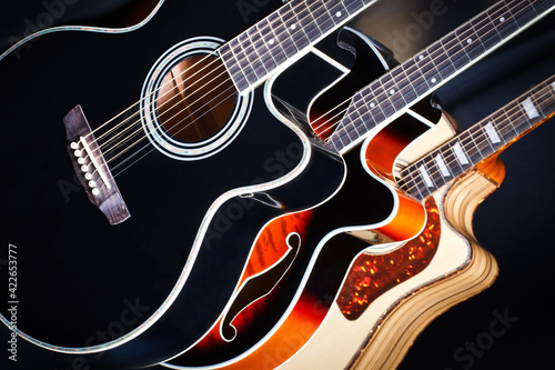 Set of acoustic guitars. Multicolored acoustically guitars close-up. They symbolize a shop for guitarists. Three guitars in a music store. Musical instrument shop. Instruments for musician