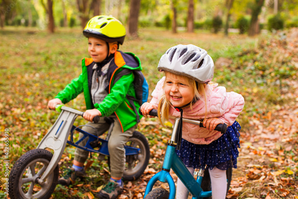 Naklejka premium Fearless and active girl on a balance bike