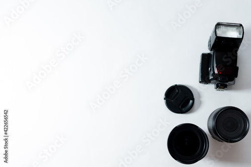 CAMERA AND CAMERA ACCESSORIES ON WHITE BACKGROUND