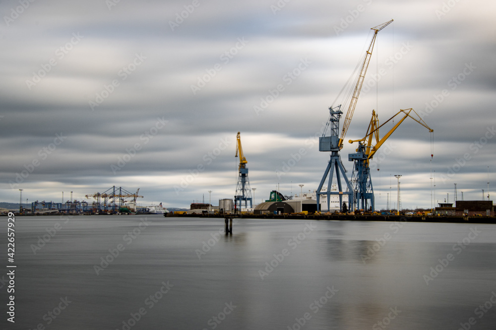 Long  exposure photograph of cranes in Belfast harbor, industrial shipyard.