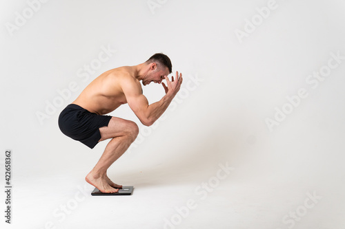 Man with weights health pondered, health and sports on a white background hurt muscle, ill man background medical, hand expression. Tension red sickness, problem suffer attractive