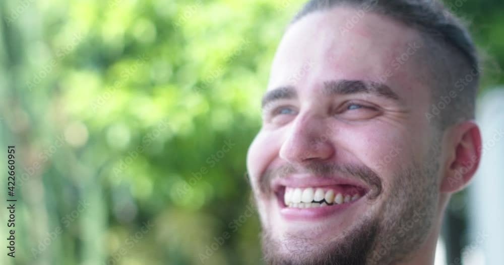 Closeup of a smiling young latin caucasian man. Brazilian guy. Joy, positive and love. Beautiful blue eyes. 4K. Closeup of a smiling young latin caucasian man. Brazilian guy. Joy, positive and love. Beautiful blue eyes. 4K.
