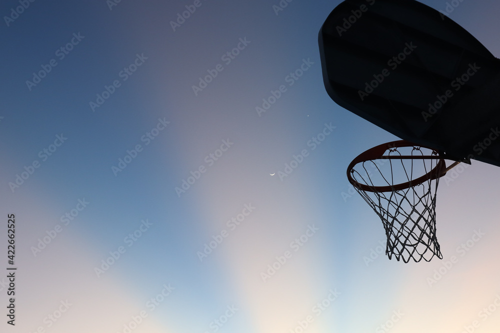 Neighborhood Basketball Hoops and Colorful Skies