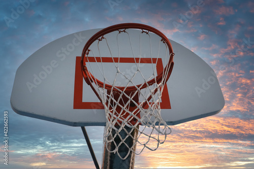 Neighborhood Basketball Hoops and Colorful Skies