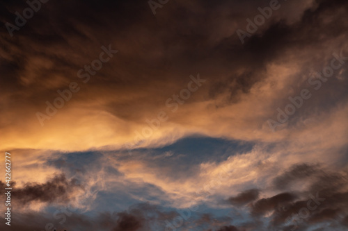 Beautiful sunset . The clouds in the sky have golden and orange colors. © Horacio Selva